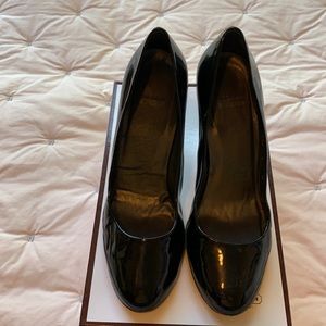 Stuart Weizmann black patent leather pumps.